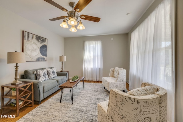 living area featuring wood finished floors and a ceiling fan