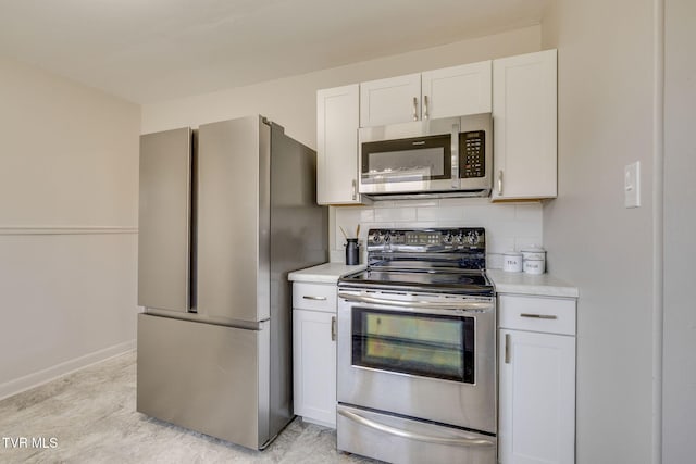 kitchen featuring decorative backsplash, light countertops, white cabinetry, and stainless steel appliances