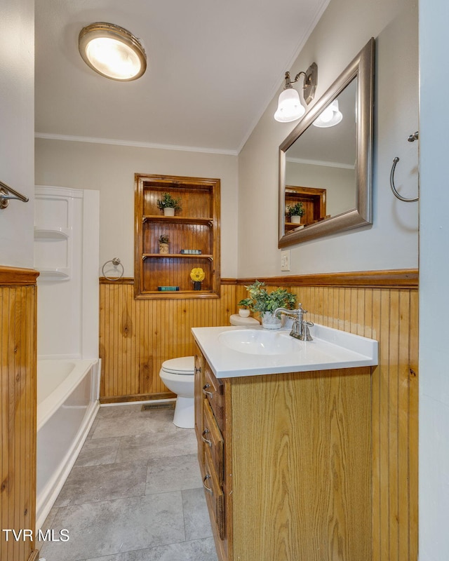 bathroom with wainscoting, vanity, and toilet