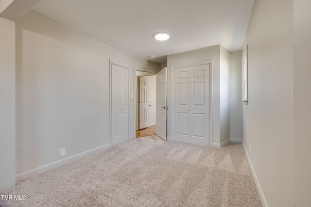 unfurnished bedroom featuring baseboards and carpet floors