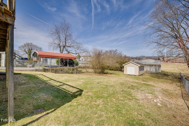 view of yard with an outbuilding, a shed, and fence