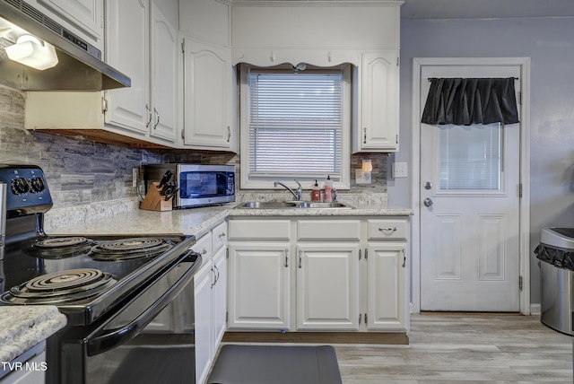 kitchen featuring a sink, white cabinets, under cabinet range hood, stainless steel microwave, and black electric range oven