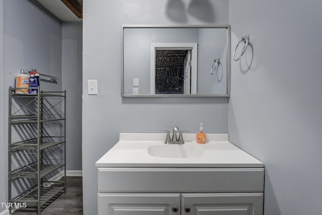 bathroom with wood finished floors and vanity