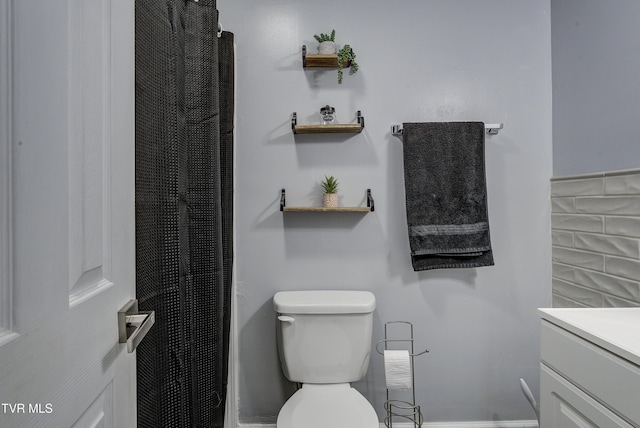 bathroom with vanity, toilet, and a shower with curtain