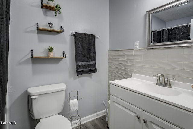 full bathroom featuring toilet, vanity, and wood finished floors