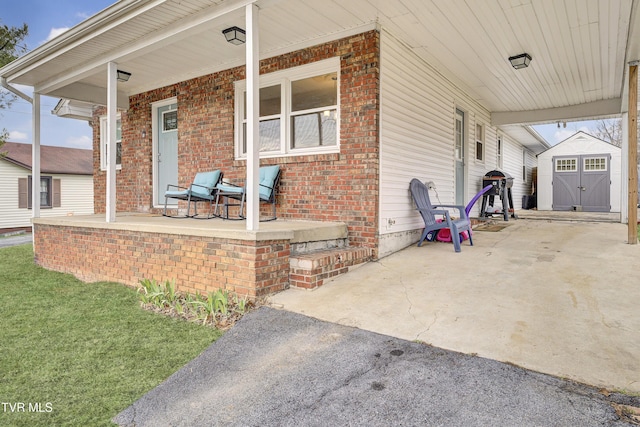 view of patio featuring an attached carport, an outbuilding, a storage unit, and covered porch