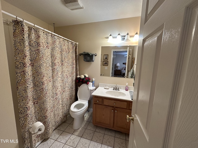 bathroom with vanity, toilet, visible vents, and tile patterned flooring