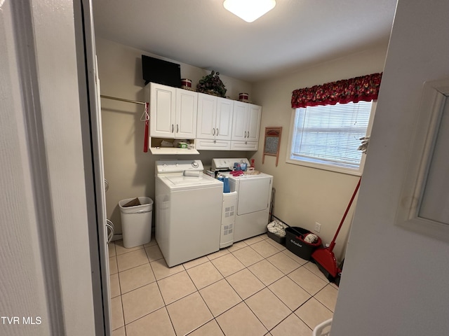 laundry area with light tile patterned floors, cabinet space, and independent washer and dryer