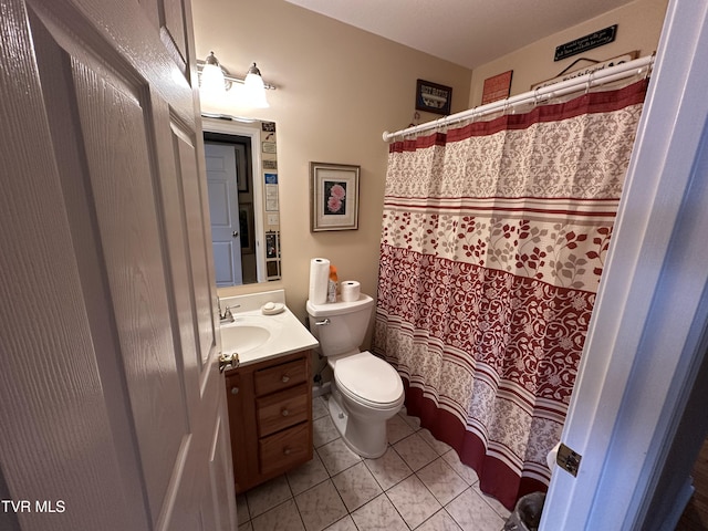 bathroom featuring tile patterned flooring, a shower with curtain, toilet, and vanity