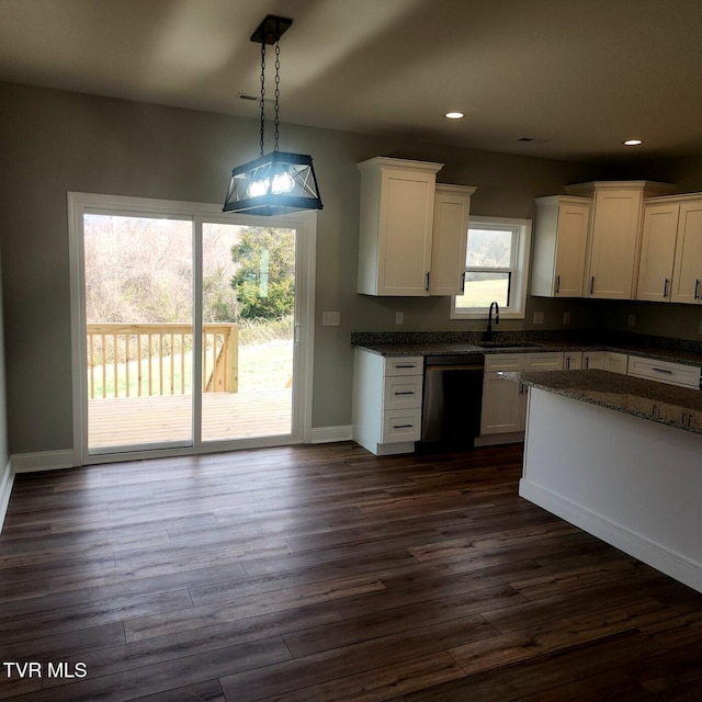 kitchen featuring dark wood-type flooring, dishwasher, recessed lighting, white cabinets, and a sink