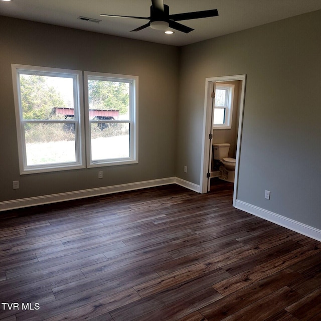 empty room featuring a ceiling fan, visible vents, baseboards, recessed lighting, and dark wood-type flooring