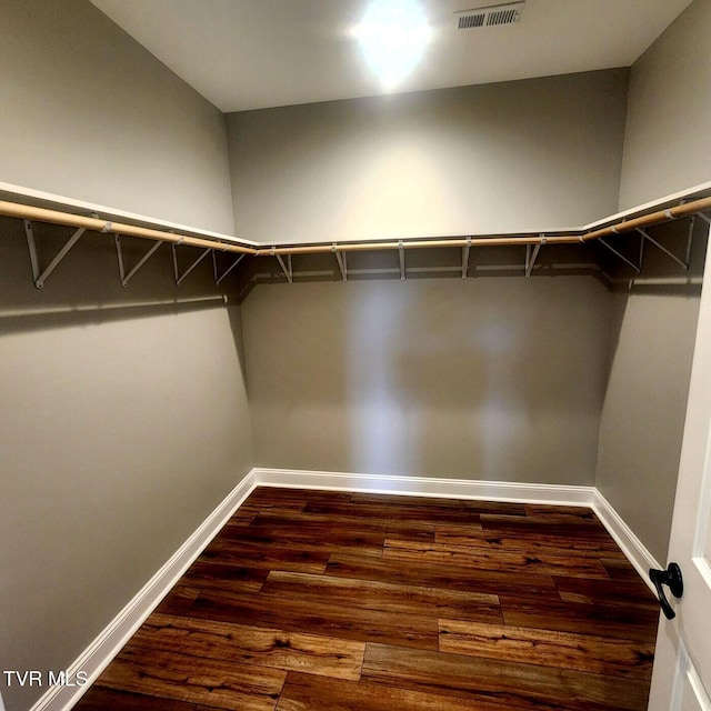 walk in closet featuring visible vents and wood finished floors