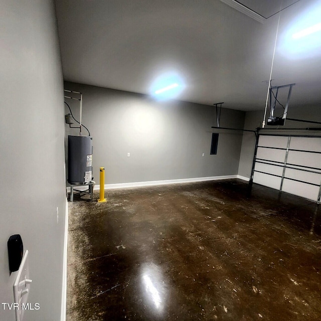 garage featuring baseboards, electric water heater, and a garage door opener