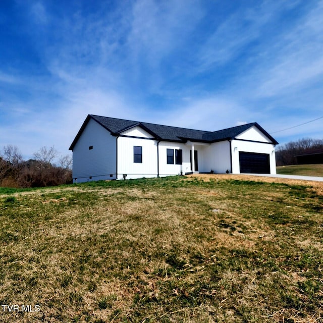 modern farmhouse style home featuring crawl space, driveway, a front yard, and an attached garage