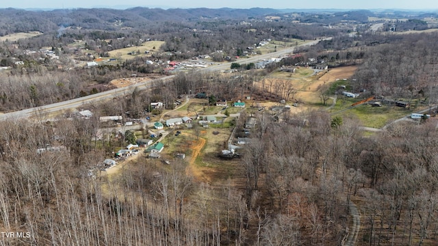 drone / aerial view featuring a forest view