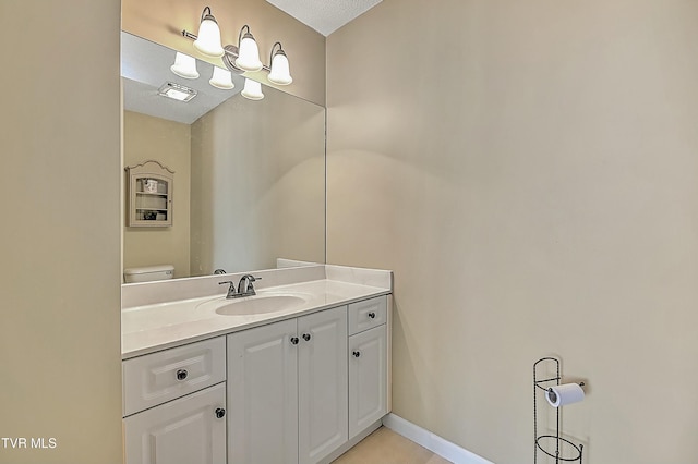 bathroom with visible vents, baseboards, toilet, and vanity