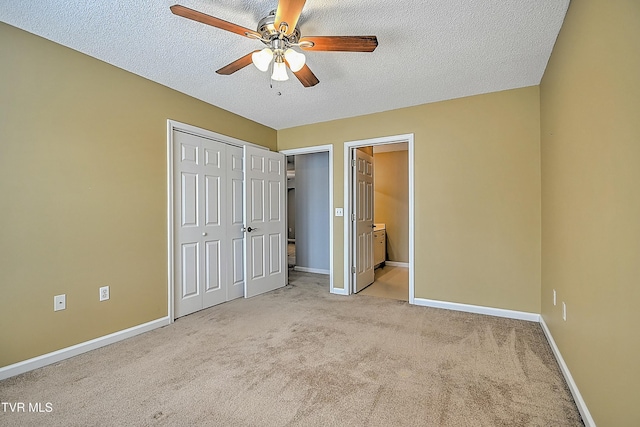 unfurnished bedroom with a ceiling fan, baseboards, carpet floors, and a textured ceiling