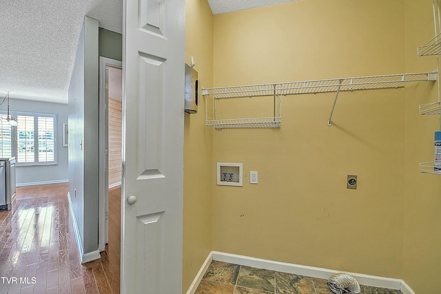 laundry area with hookup for an electric dryer, hookup for a washing machine, laundry area, and a textured ceiling