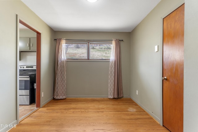 interior space with light wood-style flooring and baseboards