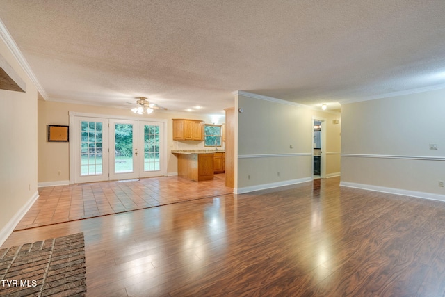 631 Bowmantown Rd, Telford, TN 37690 - unfurnished living room featuring a textured ceiling, ornamental molding, wood finished floors, ceiling fan, and baseboards