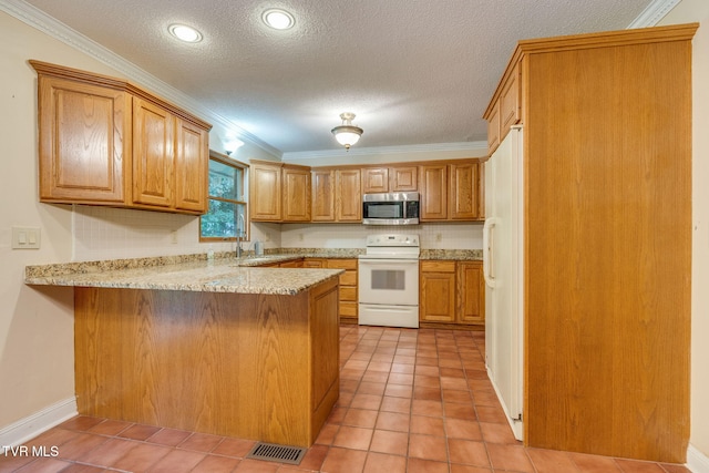 631 Bowmantown Rd, Telford, TN 37690 - kitchen with white appliances, a peninsula, light tile patterned floors, brown cabinetry, and a textured ceiling