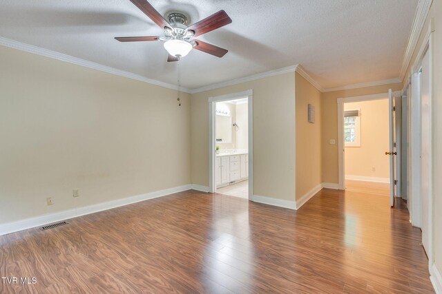 631 Bowmantown Rd, Telford, TN 37690 - spare room with a ceiling fan, light wood-style floors, crown molding, baseboards, and a textured ceiling