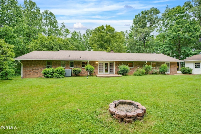 631 Bowmantown Rd, Telford, TN 37690 - view of front of property with french doors, a fire pit, a front yard, brick siding, and cooling unit