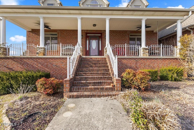 property entrance featuring brick siding, a porch, and ceiling fan