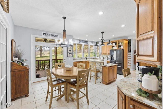 dining area with light tile patterned floors, recessed lighting, a textured ceiling, and an inviting chandelier