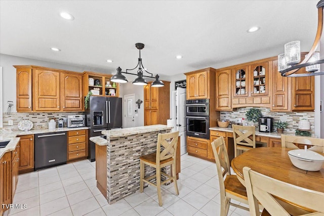 kitchen featuring dishwasher, double wall oven, black fridge with ice dispenser, and brown cabinets