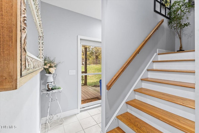 stairway with tile patterned flooring and baseboards