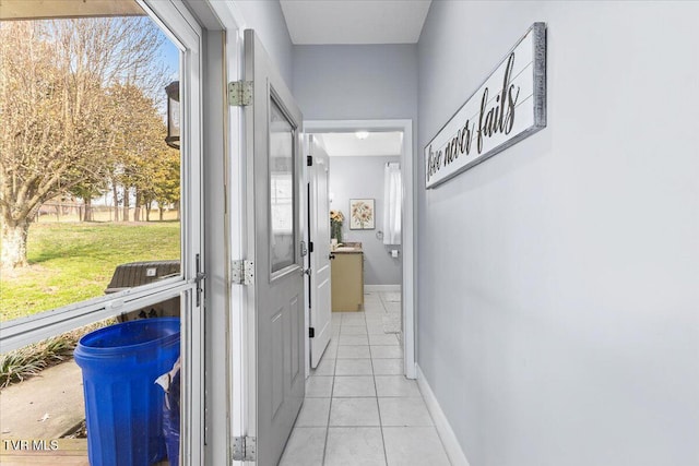 hall with light tile patterned floors and baseboards