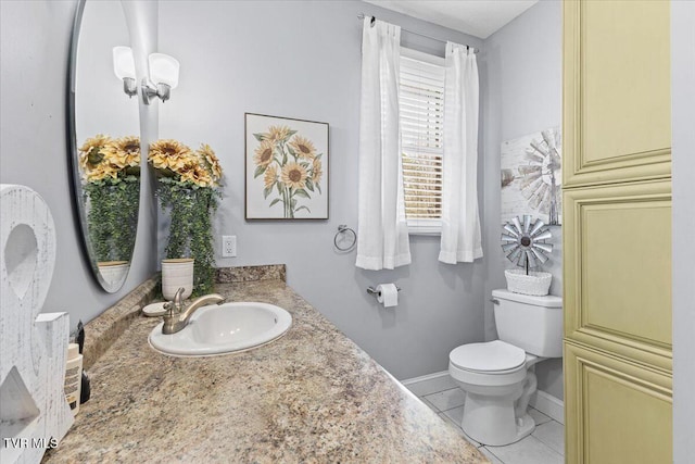 bathroom with tile patterned floors, baseboards, toilet, and vanity