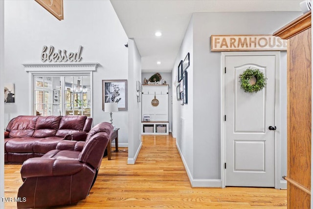 corridor with light wood finished floors, recessed lighting, and baseboards