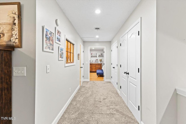 hall featuring recessed lighting, visible vents, baseboards, and carpet floors