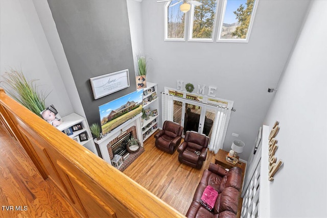 living room with ceiling fan and wood finished floors