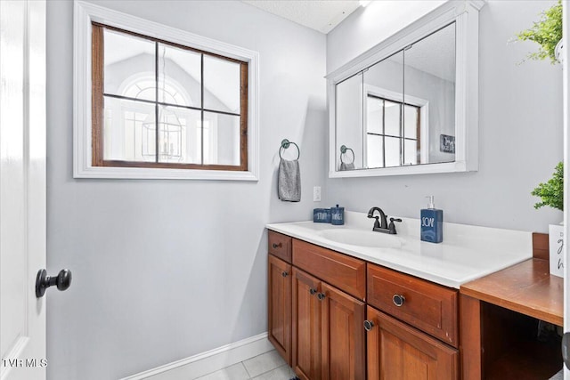 bathroom featuring tile patterned floors, vanity, and baseboards