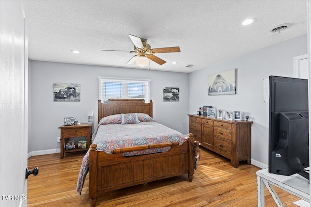 bedroom featuring visible vents, light wood-type flooring, and baseboards