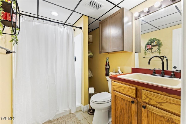 full bath with tile patterned floors, visible vents, toilet, a paneled ceiling, and vanity