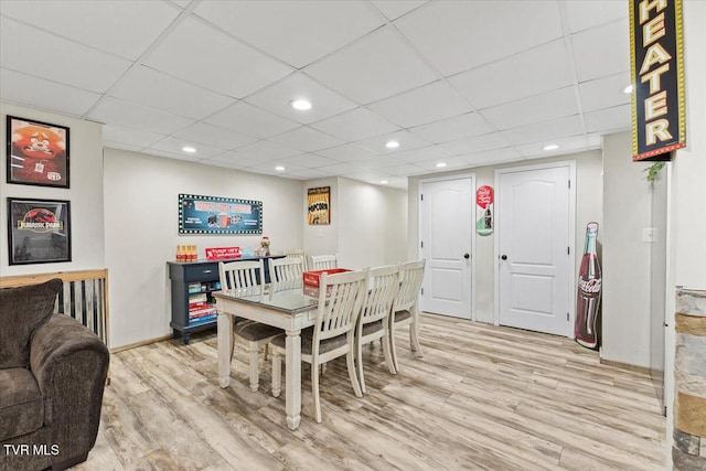 dining area featuring recessed lighting, light wood-type flooring, and a drop ceiling