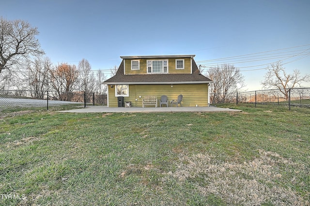 back of property featuring a yard, roof with shingles, a fenced backyard, and a patio area