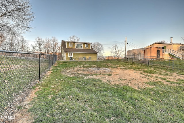 view of yard featuring an outdoor fire pit and a fenced backyard