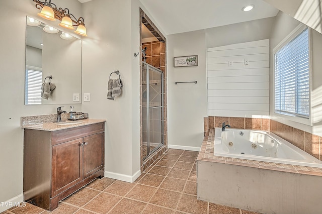 full bath with baseboards, vanity, a tub with jets, and a shower stall