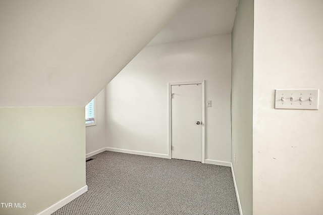 bonus room with carpet floors, baseboards, and vaulted ceiling