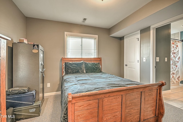 bedroom with light tile patterned floors, visible vents, and baseboards