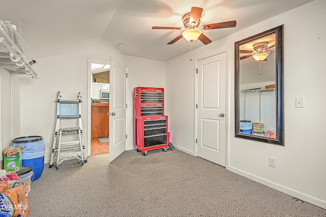 interior space featuring baseboards, carpet floors, and ceiling fan