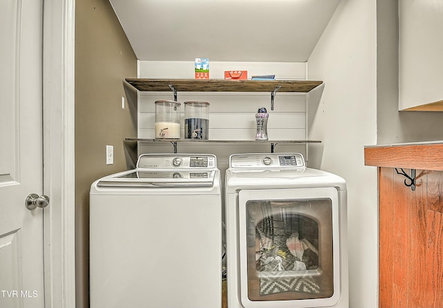 laundry area with washing machine and clothes dryer and laundry area