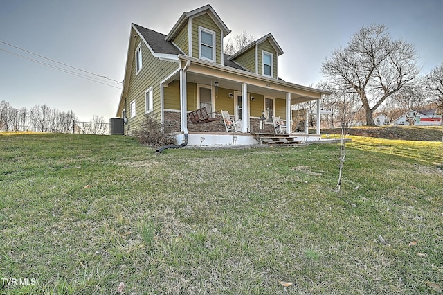 view of front facade with stone siding, a porch, and a front lawn