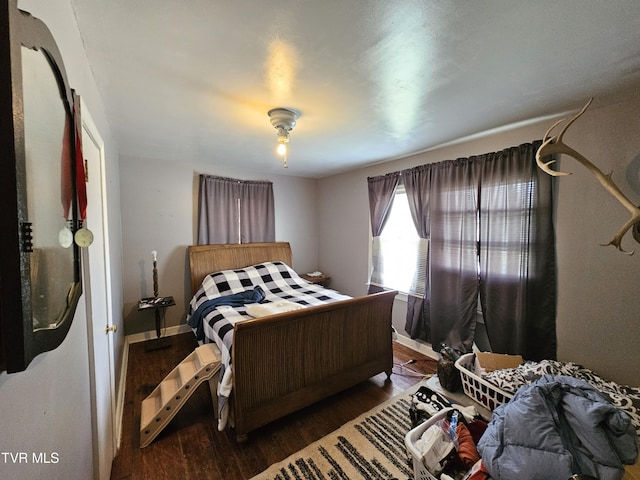 bedroom featuring baseboards and wood finished floors