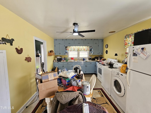 kitchen with light tile patterned floors, a ceiling fan, separate washer and dryer, freestanding refrigerator, and blue cabinets